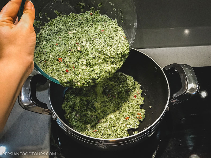 cooking persian herb frittata - kuku sabzi